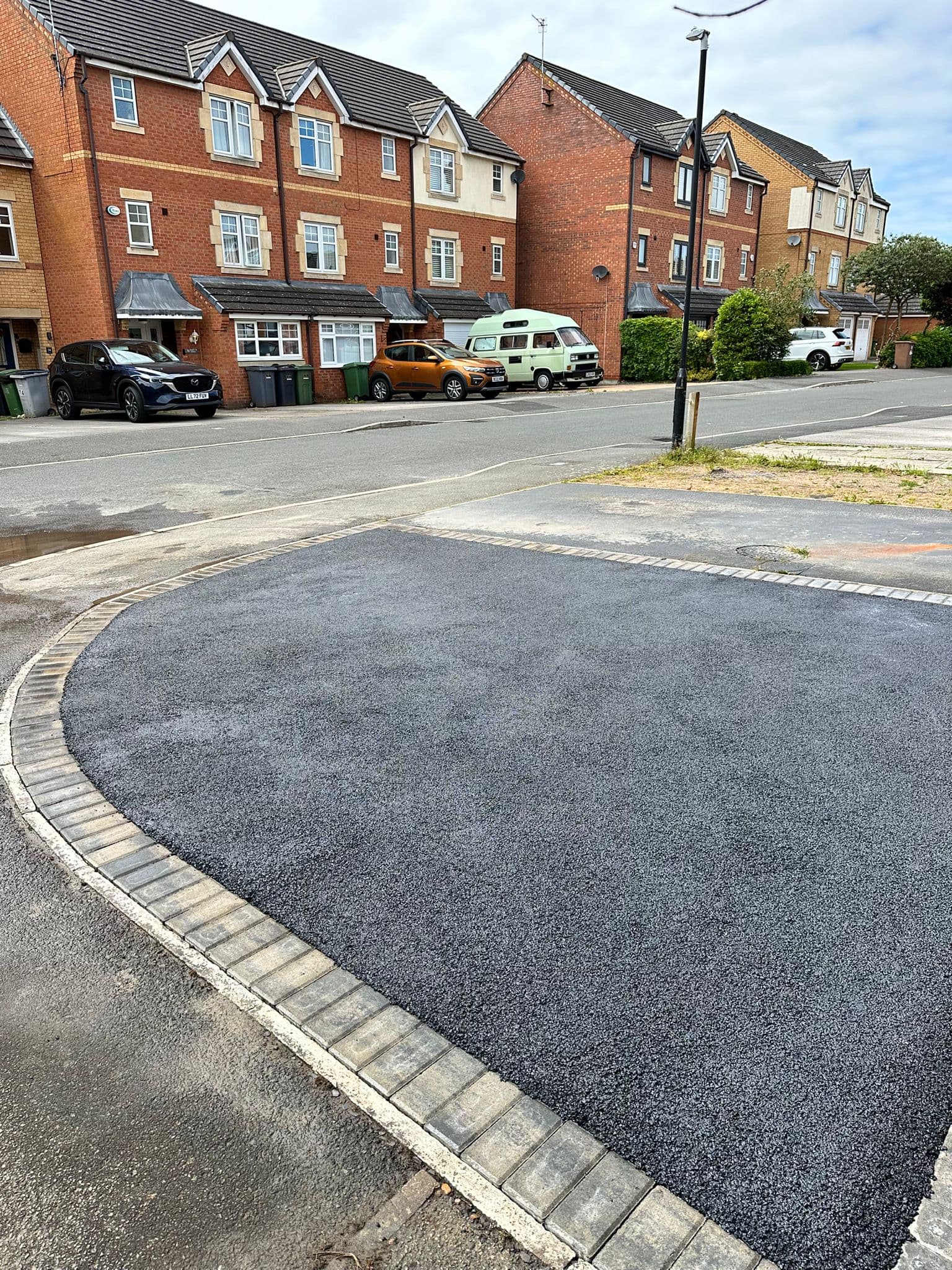 Finished tarmac driveway with a block paved edging course